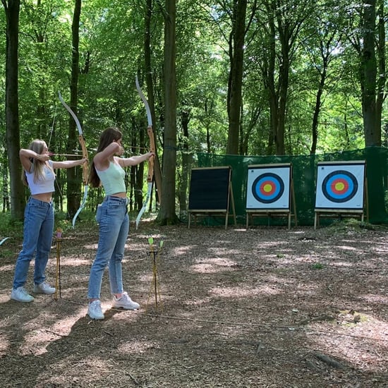 Two girls taking part in Archery at Forest Holidays