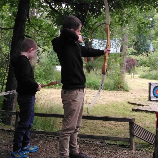 Two young boys taking part in Archery at Forest Holidays