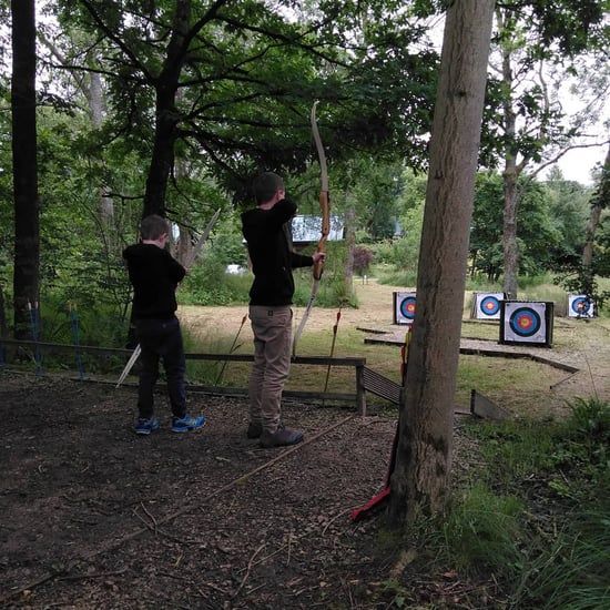 Two young boys taking part in Archery at Forest Holidays