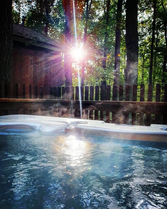 Hot tub shot with a sunburst through the trees by @kim.runs.a.marathon