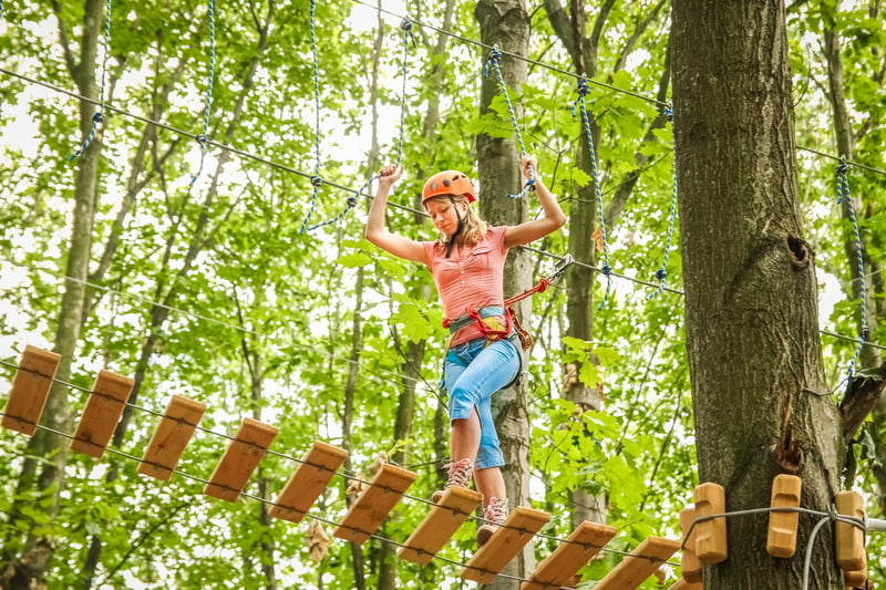 Girl on high ropes in the forest at Go Ape